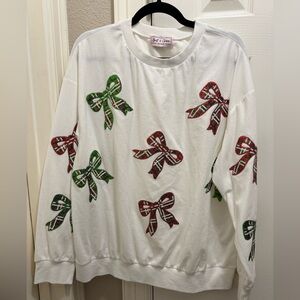 Chic White Sweater with Festive Bow Accents